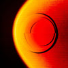 3D light art installation on wall with a vibrant red and orange gradient glow