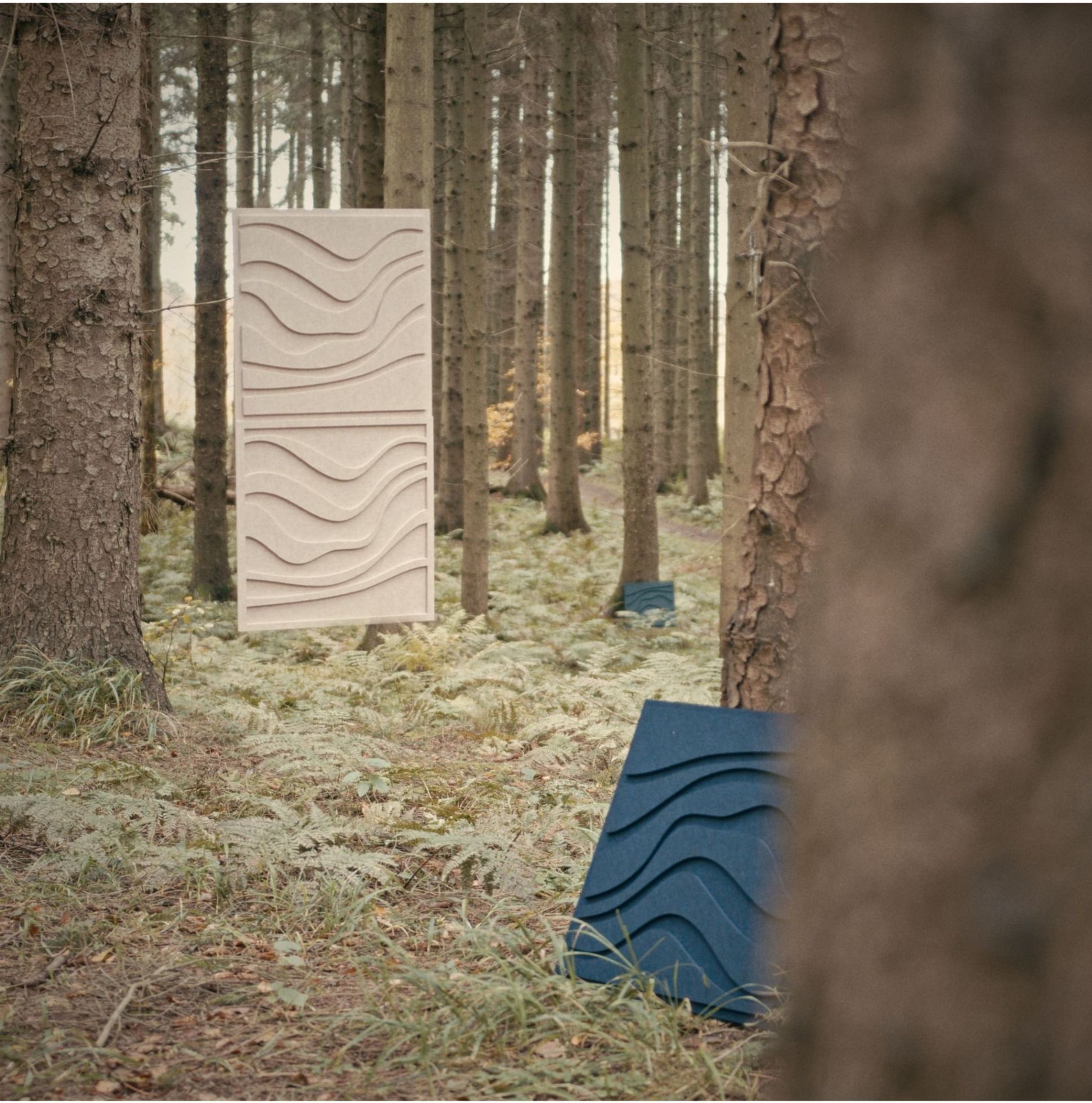 Wave tile set from Arturel displayed in a natural forest setting, showcasing sustainability and acoustic design