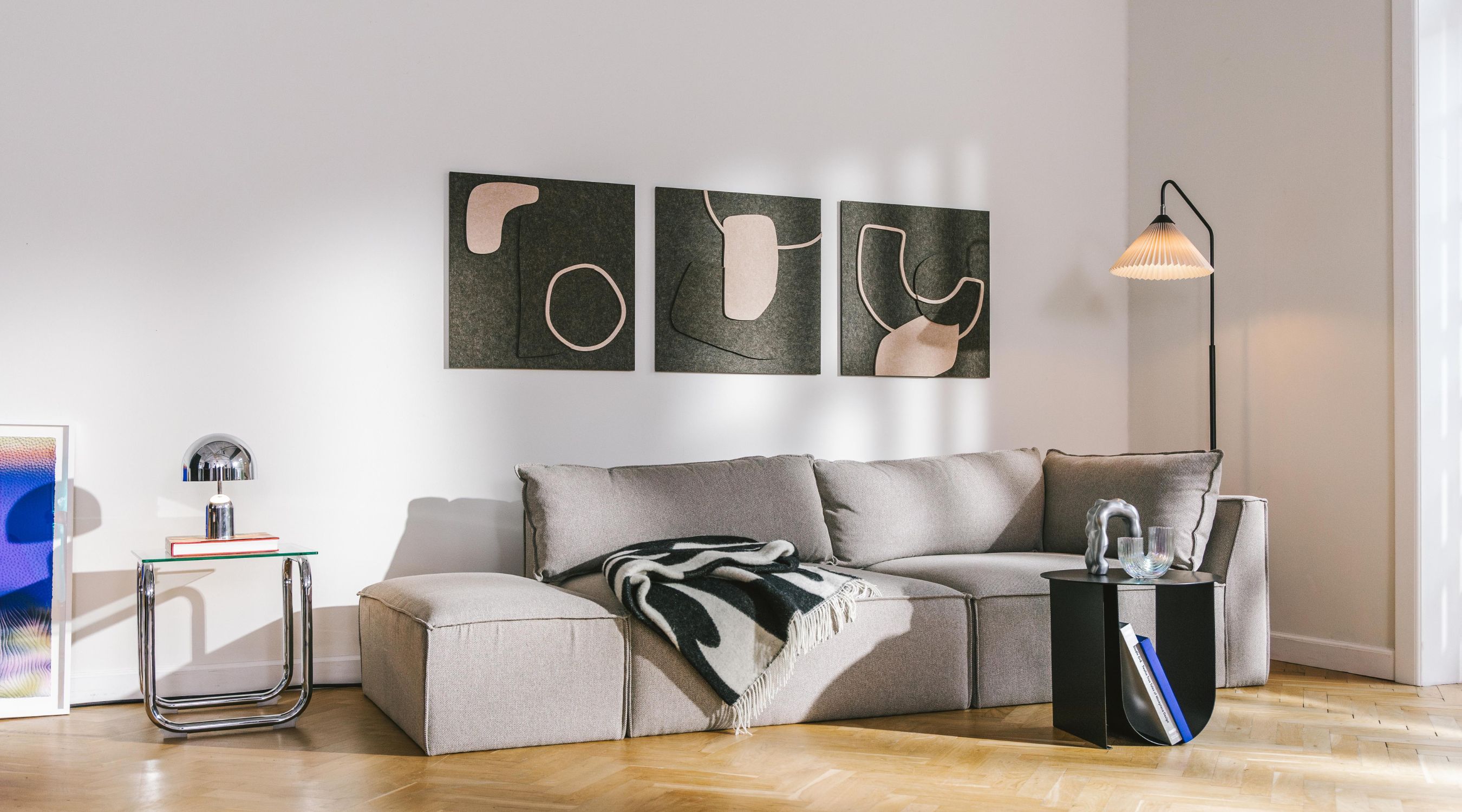 Sound absorbing artwork from Arturel here in the form of the Bauhaus models in black and beige hanging in the living room