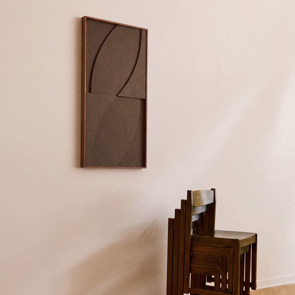Side view of a medium sized textile acoustic artwork in dark brown color with an oak frame.